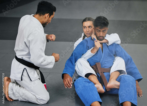 Принти на полотні Karate training with trainer at a fitness studio, learning defense moves and practising fighting for competition together at a gym