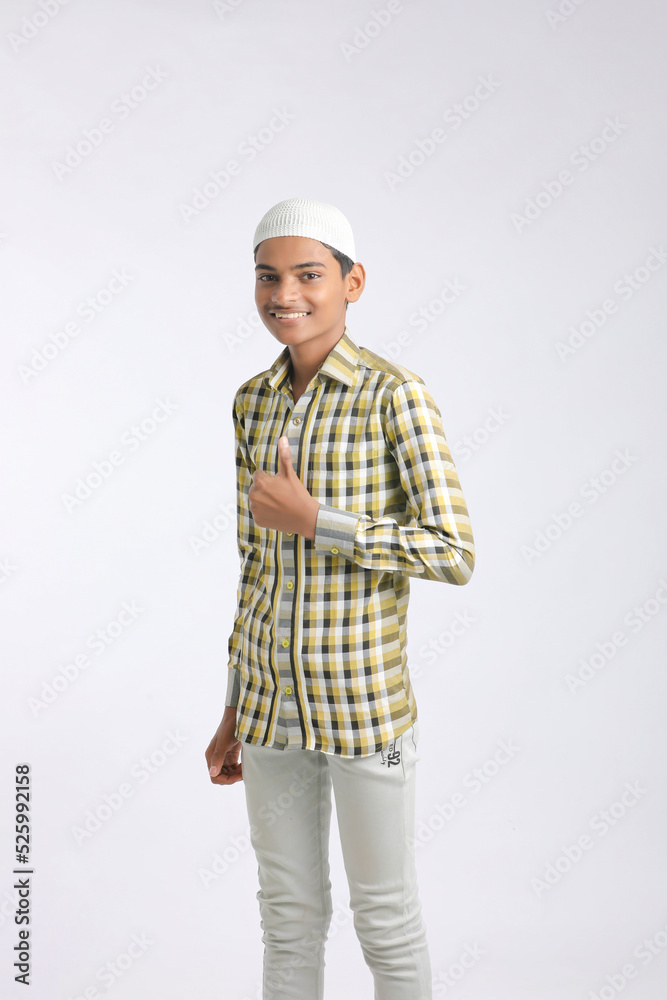 Indian muslim boy giving expression on white background. Indian muslim boy giving expression on white background.