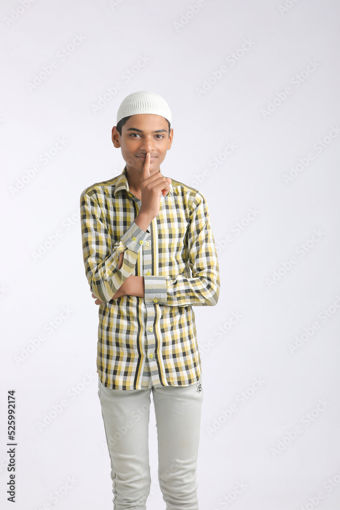 Indian muslim boy giving expression on white background. Indian muslim boy giving expression on white background.