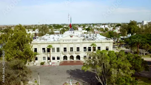 Drone zooming in focusing a mexican university flying from the front to the roof of the building photo