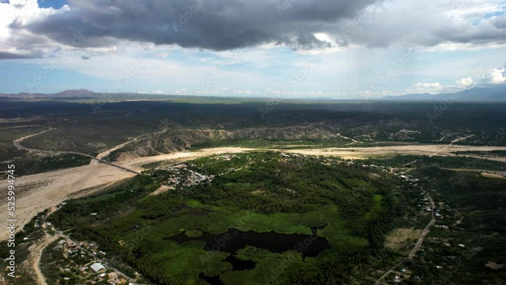 drone shot of the central lake and palm plantations inside an oasis in baja california sur near los cabos mexico during a storm drone shot of the central lake and palm plantations inside an oasis in baja california sur near los cabos mexico during a storm