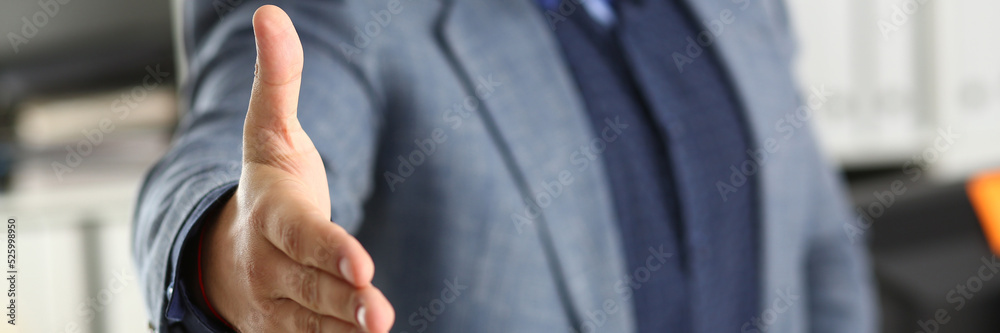 Businessman working in the office, reaching out hand forward for handshake