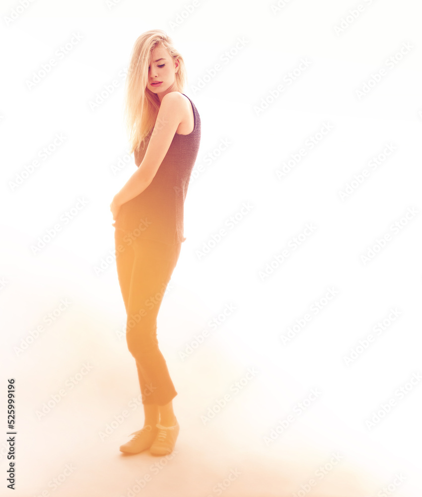 Fashion, model and beauty with a sexy woman in studio on a creative and white background. Young female posing in modern and elegant clothes, looking confident, proud and beautiful on sensual lighting