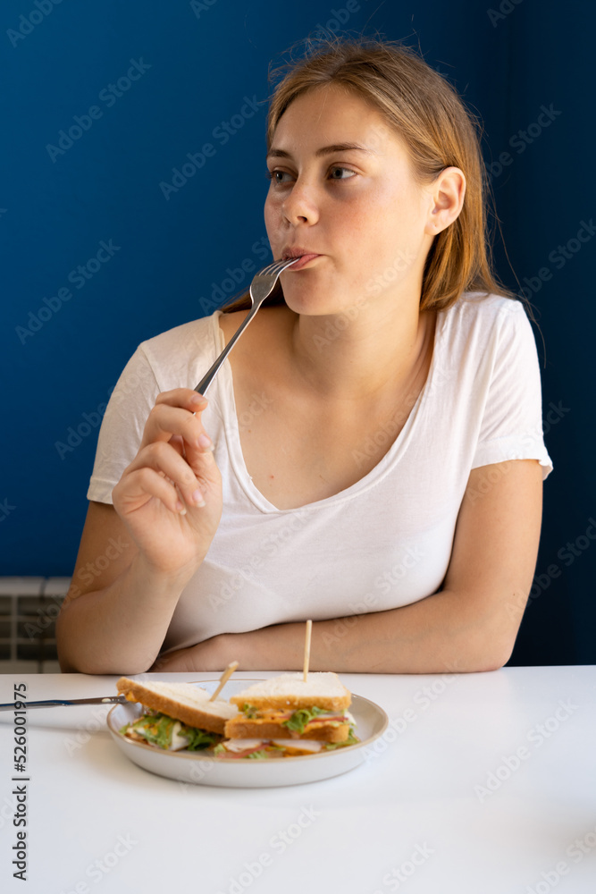 Charming woman having lunch during the rest in coffee shop, Caucasian female eating breakfast while relaxing in cafe during free time. Food and people Charming woman having lunch during the rest in coffee shop, Caucasian female eating breakfast while relaxing in cafe during free time. Food and people