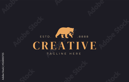 Bear Logo Design. Bear Catches a Salmon Silhouette Vector Animal