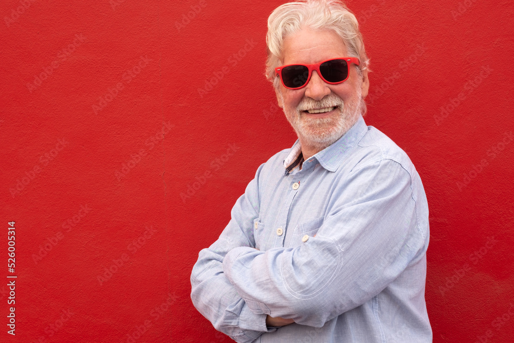 Senior handsome white-haired man wearing casual shirt over red background with a happy and cool smile on face. Lucky person. Senior handsome white-haired man wearing casual shirt over red background with a happy and cool smile on face. Lucky person.