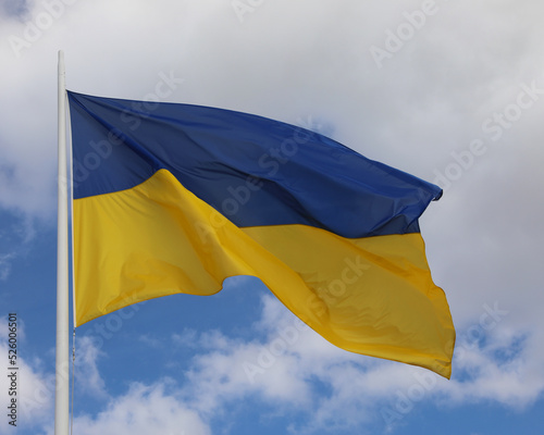 Fotografie flag of Ukraine with blue sky and clouds