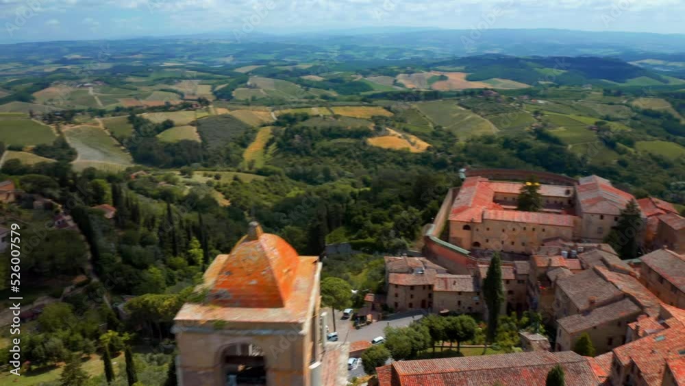 Tuscan Landscape With Green Fields And San Gimignano Medieval Town In Tuscany, Italy - aerial drone shot Tuscan Landscape With Green Fields And San Gimignano Medieval Town In Tuscany, Italy - aerial drone shot
