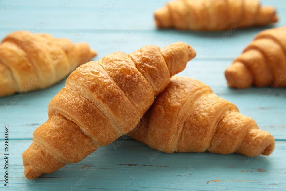 Freshly baked croissants on blue wooden background Warm Fresh Buttery Croissants and Rolls. French and American Croissants and Baked Pastries