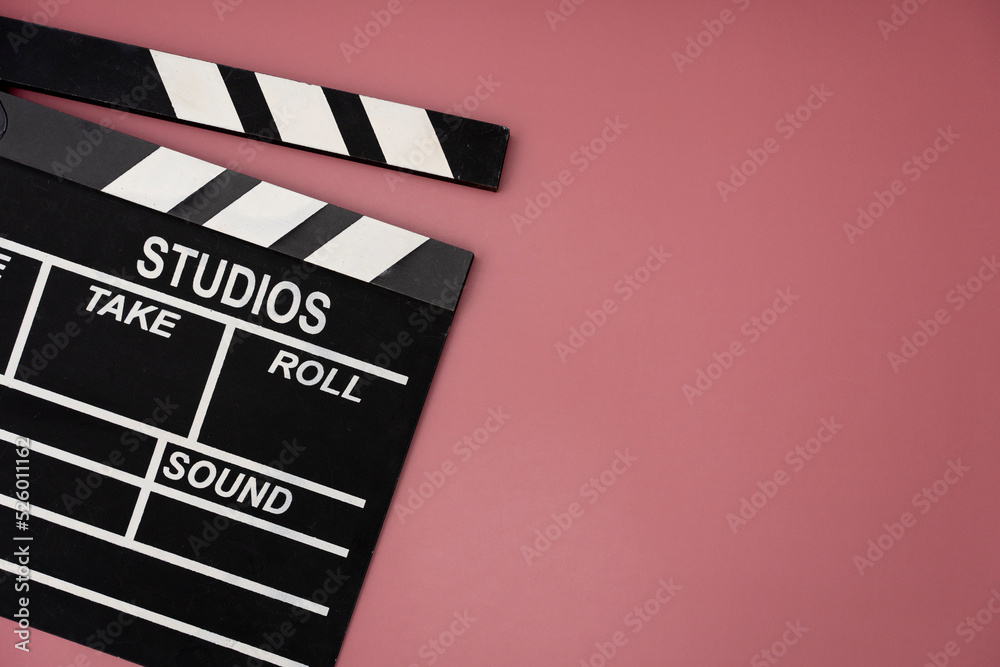 Naklejka premium movie clapper on table background ; film, cinema and video photography concept