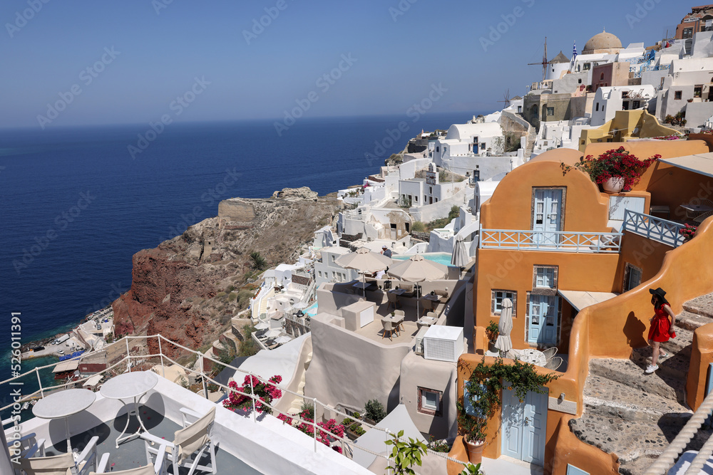  Whitewashed houses with terraces and pools and a beautiful view in Oia on Santorini island, Greece