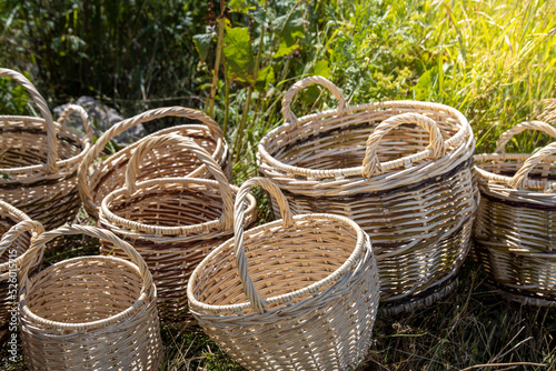 baskets woven by hand lie on the grass.