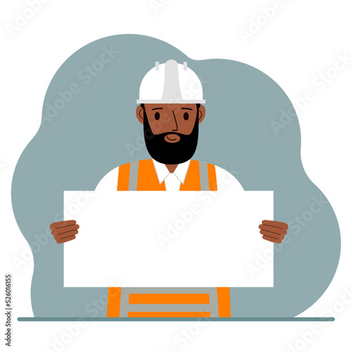 Engineer man holding a blank sheet of paper. The concept of a builder, engineer, planner or designer.