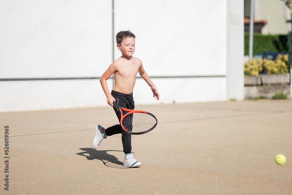 Shirtless boy playing tennis on street Stock Photo Adobe Stock