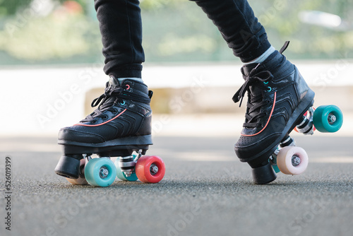 Crop child walking in roller skates photo