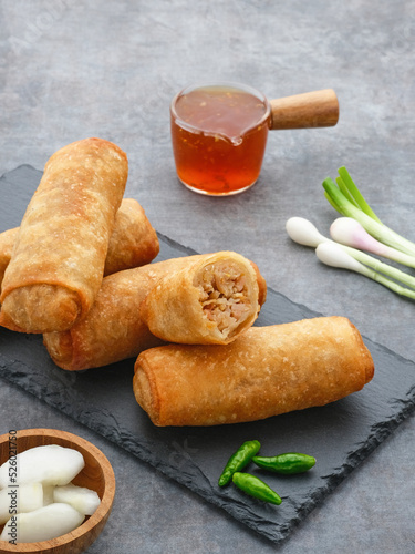 Lumpia or lunpia, traditional snacks from Semarang, Central Java, Indonesia. Traditional spring rolls contain stir-fried bamboo shoots (rebung), eggs, and chicken or shrimp. 
 photo