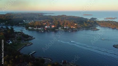 Drone footage of speedboats in the water near the coastal Grimstad City in Norway photo