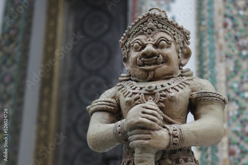 Selective focus of a small Rahu statuette with the blurred background photo