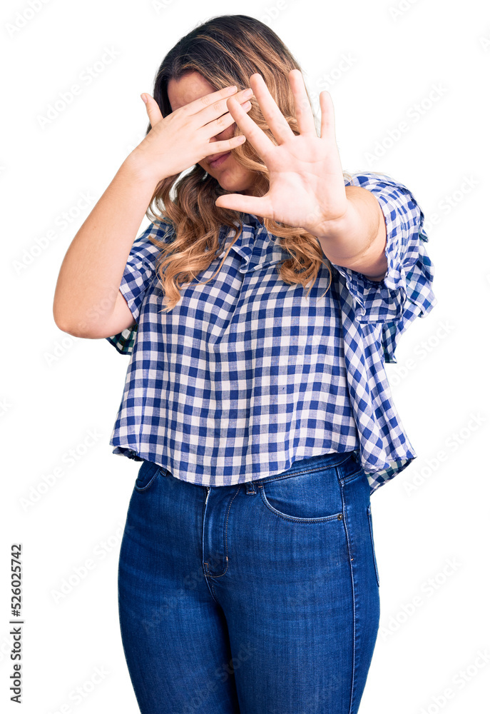 Young caucasian woman wearing casual clothes covering eyes with hands and doing stop gesture with sad and fear expression. embarrassed and negative concept. Young caucasian woman wearing casual clothes covering eyes with hands and doing stop gesture with sad and fear expression. embarrassed and negative concept.