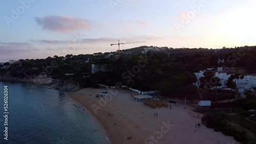 yellow construction crane builds villa on beach
Breathtaking aerial view flight fly backwards drone footage at sunset golden houre evening in spain aro summer 2022 Marnitz 4k Cinematic view from above photo