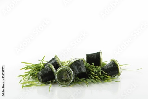 Closeup shot of wheatgrass juice isolated on a white background photo