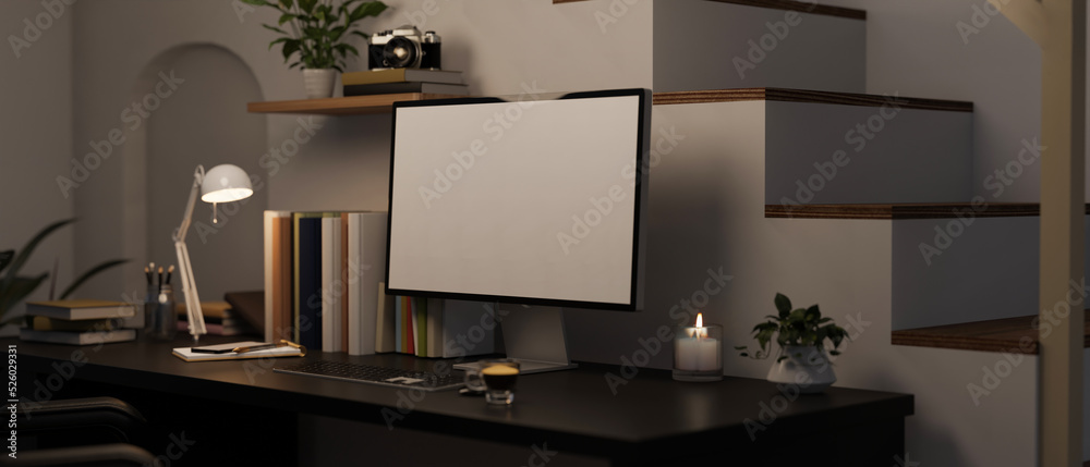 Modern home working space at night with computer mockup on black table near the stairs.