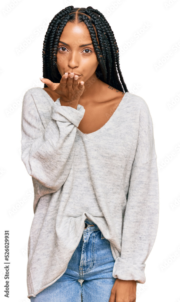 Beautiful hispanic woman wearing casual clothes looking at the camera blowing a kiss with hand on air being lovely and sexy. love expression. Beautiful hispanic woman wearing casual clothes looking at the camera blowing a kiss with hand on air being lovely and sexy. love expression.