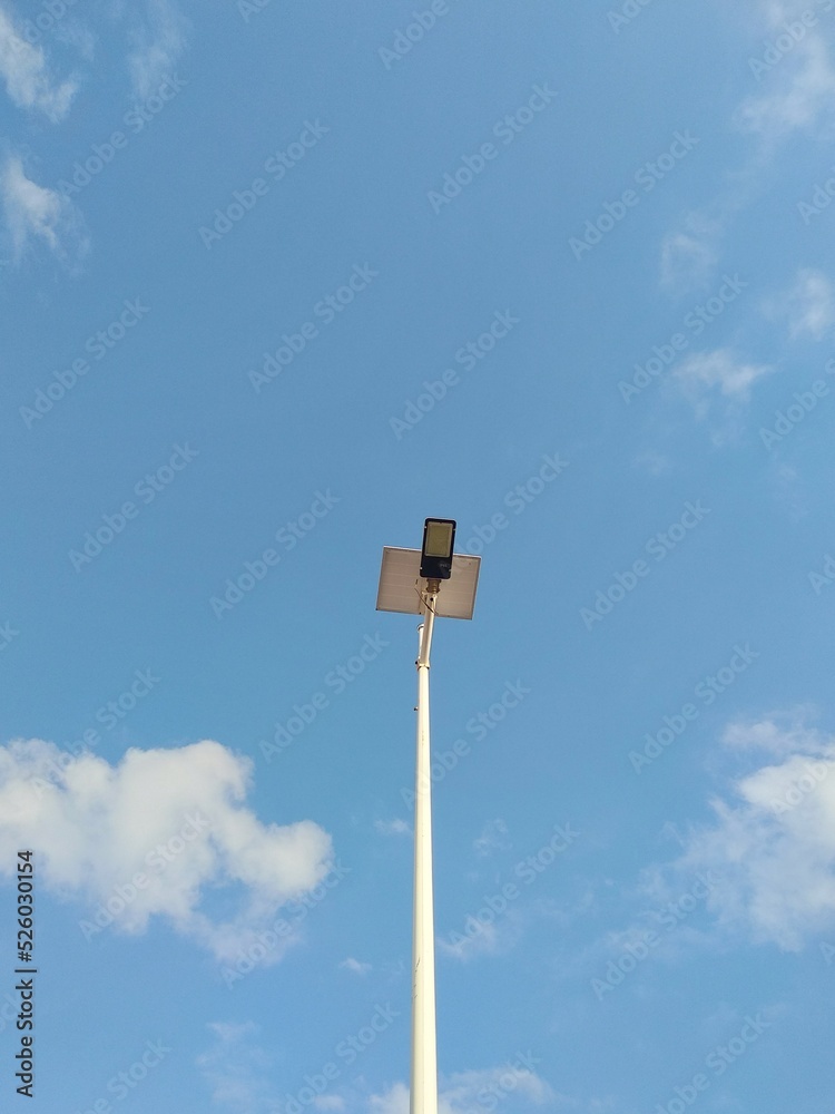 A Light Pole with Blue Sky and Clouds. Beautiful View In A Day. Perfect For Background A Light Pole with Blue Sky and Clouds. Beautiful View In A Day. Perfect For Background