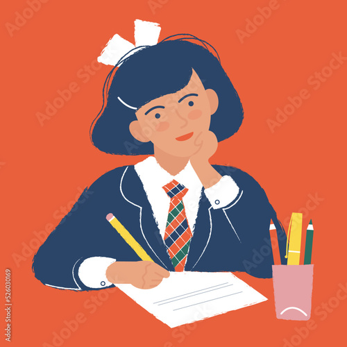 schoolgirl is writing an essay in class