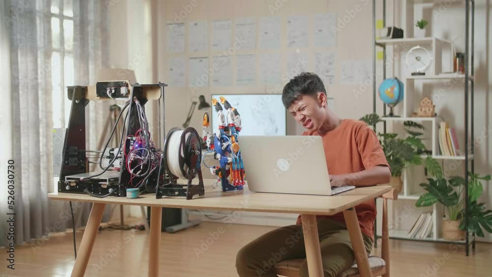 Asian Boy Having A Backache While Working About A Cyborg Hand On A Laptop At Home
Asian Boy Having A Backache While Working About A Cyborg Hand On A Laptop At Home