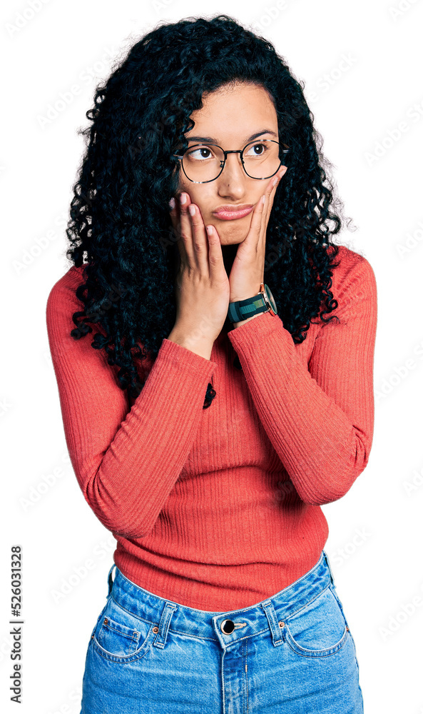 Young hispanic woman with curly hair wearing glasses tired hands covering face, depression and sadness, upset and irritated for problem Young hispanic woman with curly hair wearing glasses tired hands covering face, depression and sadness, upset and irritated for problem