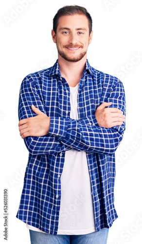 Young handsome caucasian man wearing casual clothes happy face smiling with crossed arms looking at the camera. positive person.