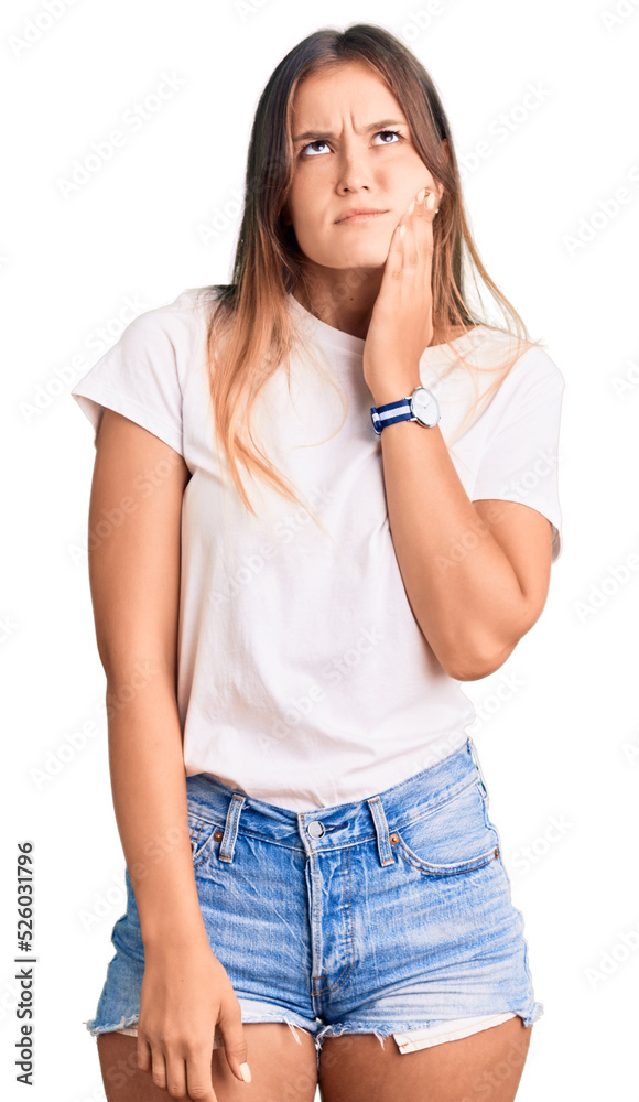 Obraz premium Beautiful caucasian woman wearing casual white tshirt touching mouth with hand with painful expression because of toothache or dental illness on teeth. dentist