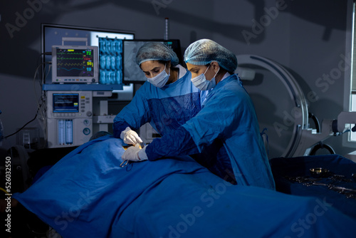 Two female surgeons performing surgery at hospital operating room  © G-images