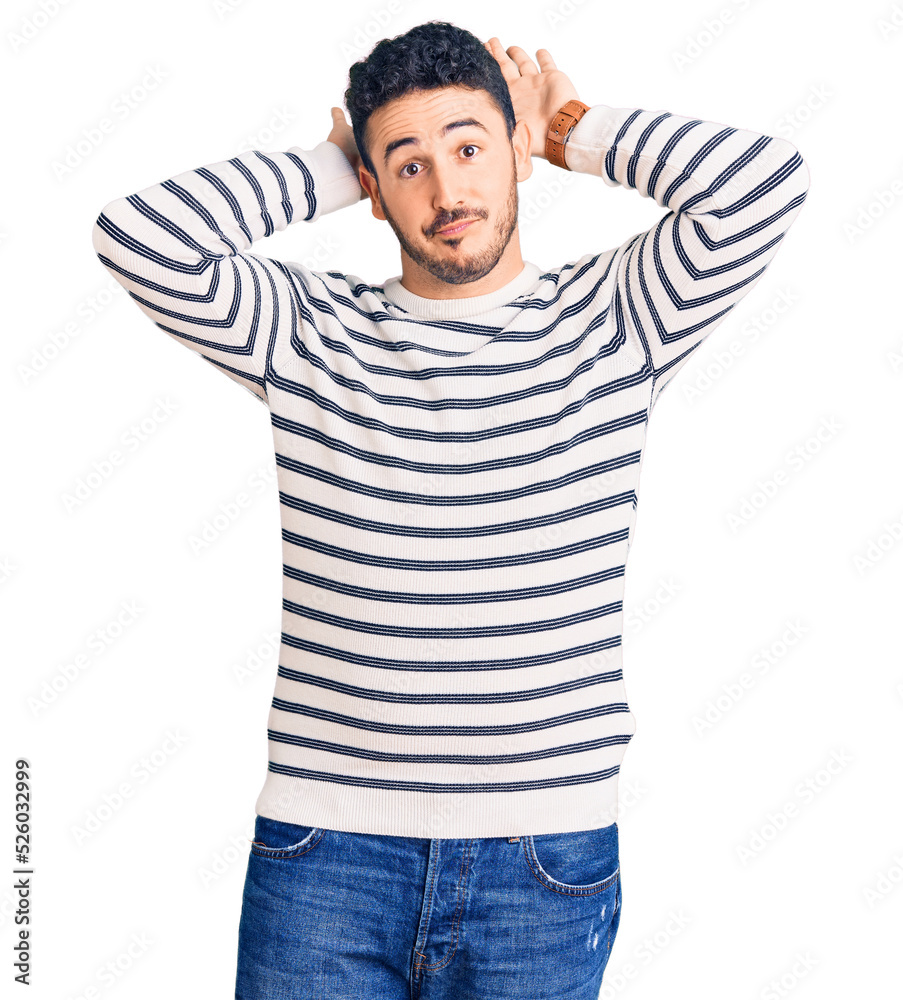 Young hispanic man wearing casual clothes doing bunny ears gesture with hands palms looking cynical and skeptical. easter rabbit concept. Young hispanic man wearing casual clothes doing bunny ears gesture with hands palms looking cynical and skeptical. easter rabbit concept.