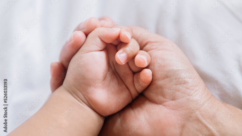 Close up baby hand on mother's hands. Close up baby hand on mother's hands.