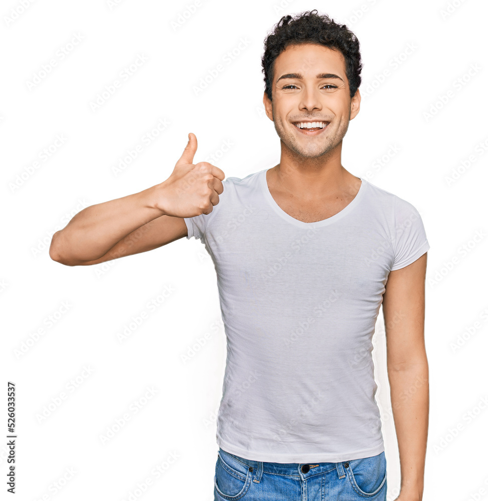 Young handsome man wearing casual white t shirt smiling happy and positive, thumb up doing excellent and approval sign Young handsome man wearing casual white t shirt smiling happy and positive, thumb up doing excellent and approval sign