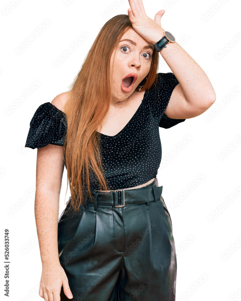 Young beautiful redhead woman wearing elegant clothes surprised with hand on head for mistake, remember error. forgot, bad memory concept. Young beautiful redhead woman wearing elegant clothes surprised with hand on head for mistake, remember error. forgot, bad memory concept.