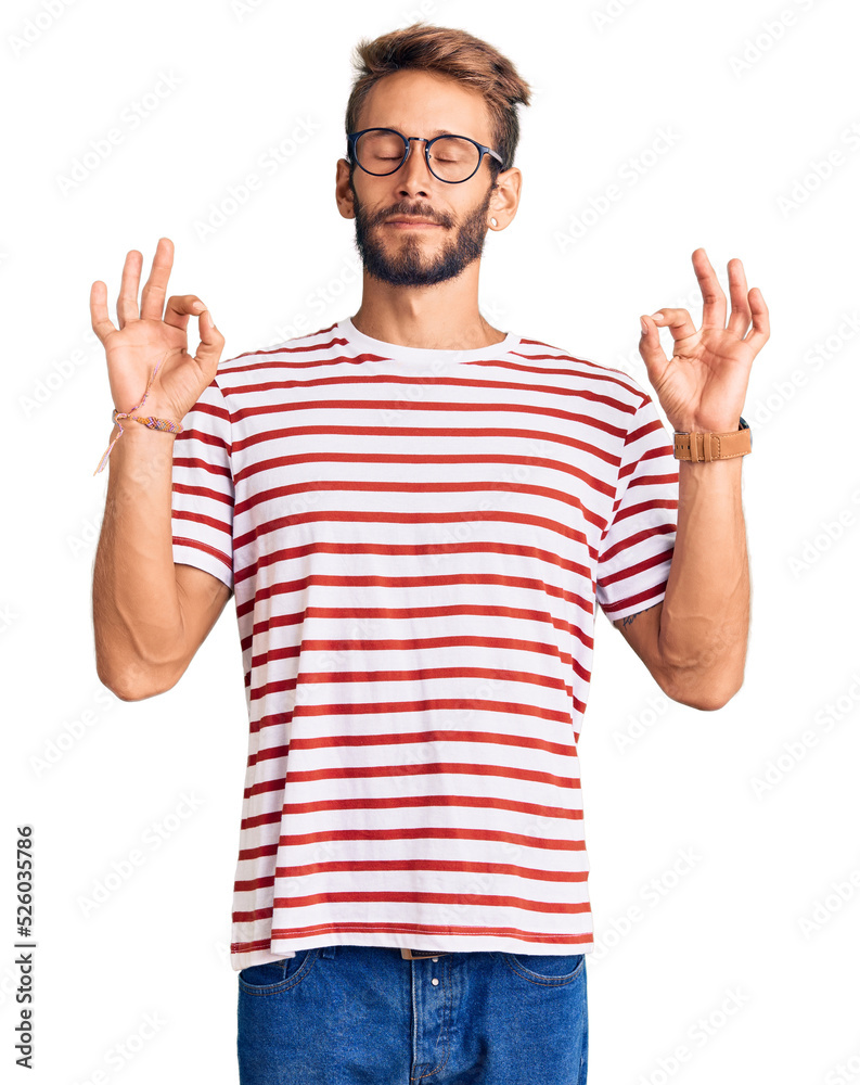 Handsome blond man with beard wearing casual clothes and glasses relaxed and smiling with eyes closed doing meditation gesture with fingers. yoga concept. Handsome blond man with beard wearing casual clothes and glasses relaxed and smiling with eyes closed doing meditation gesture with fingers. yoga concept.