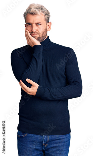 Young handsome blond man wearing casual turtleneck sweater thinking looking tired and bored with depression problems with crossed arms.