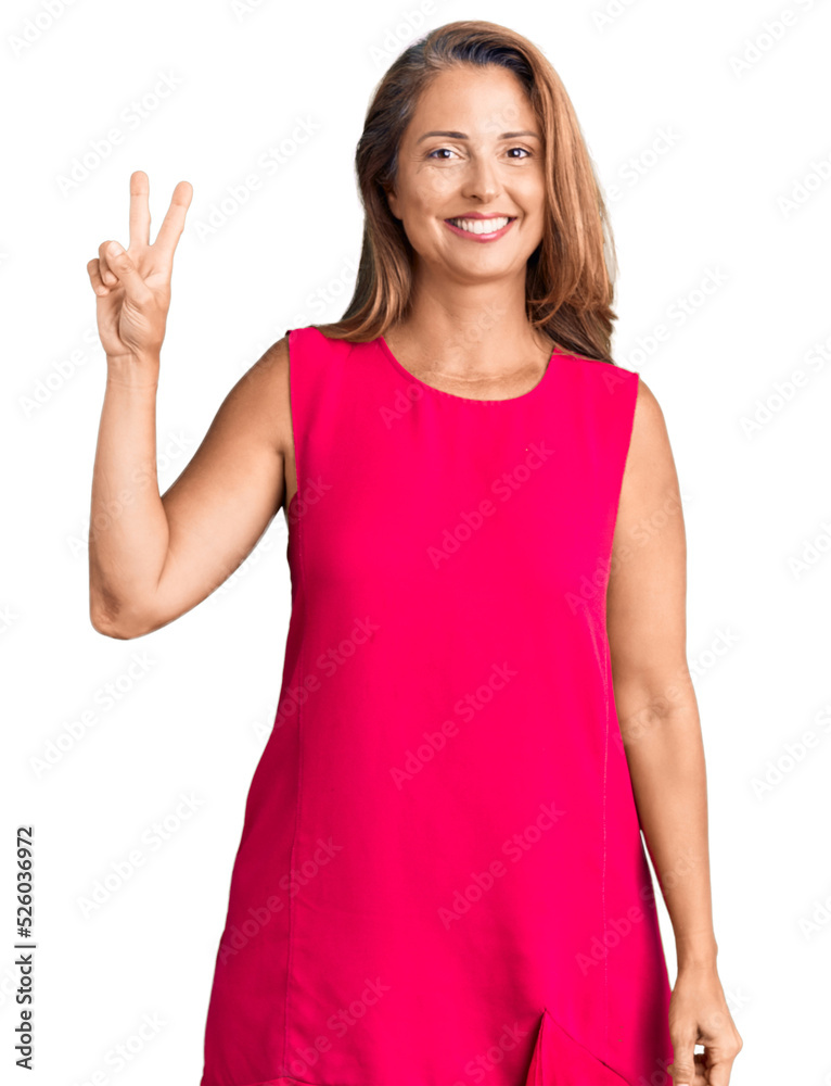 Middle age hispanic woman wearing casual clothes smiling with happy face winking at the camera doing victory sign. number two. Middle age hispanic woman wearing casual clothes smiling with happy face winking at the camera doing victory sign. number two.