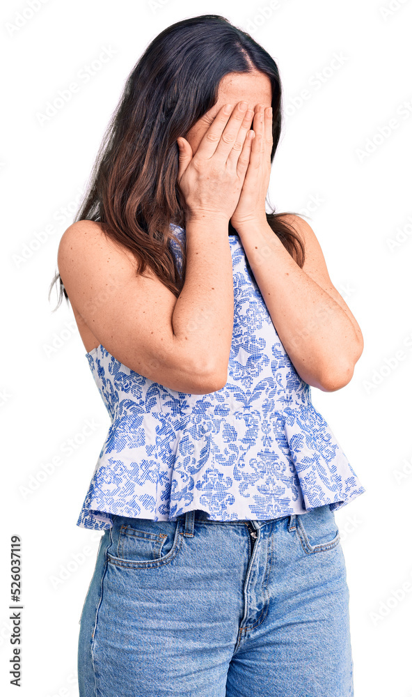 Young beautiful brunette woman wearing casual t-shirt with sad expression covering face with hands while crying. depression concept. Young beautiful brunette woman wearing casual t-shirt with sad expression covering face with hands while crying. depression concept.