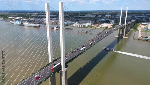 Dartford QE2 Bridge over the river Thames. Traffic crossing with a boat sailing under. photo