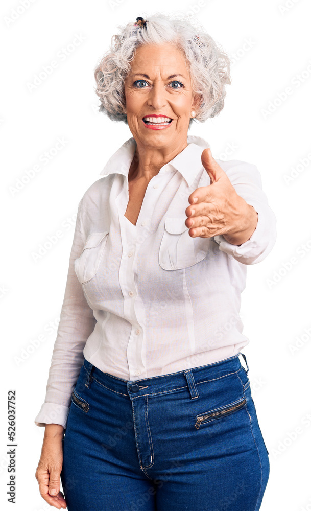 Senior grey-haired woman wearing casual clothes smiling friendly offering handshake as greeting and welcoming. successful business. Senior grey-haired woman wearing casual clothes smiling friendly offering handshake as greeting and welcoming. successful business.