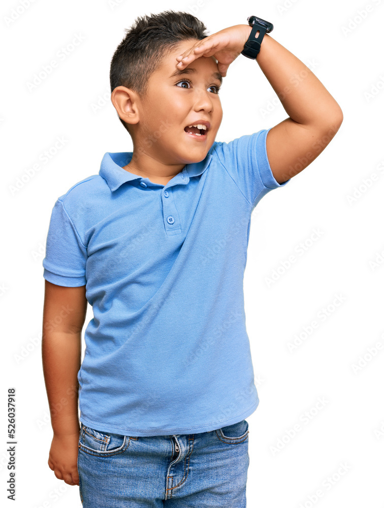 Little boy hispanic kid wearing casual clothes very happy and smiling looking far away with hand over head. searching concept. Little boy hispanic kid wearing casual clothes very happy and smiling looking far away with hand over head. searching concept.