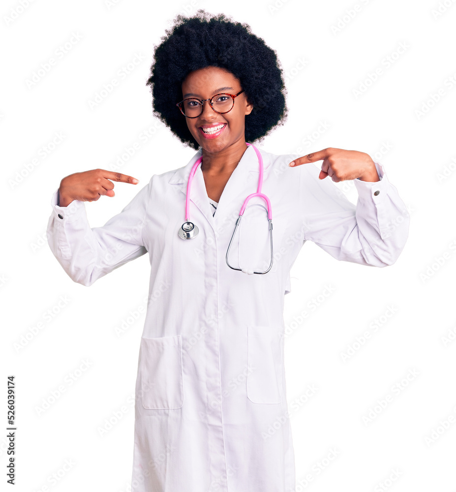Young african american woman wearing doctor coat and stethoscope looking confident with smile on face, pointing oneself with fingers proud and happy.