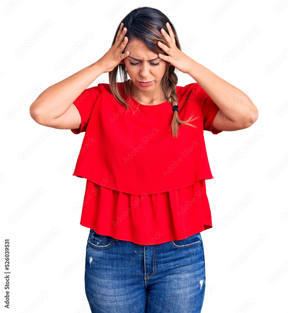 Young beautiful woman wearing casual t-shirt suffering from headache desperate and stressed because pain and migraine. hands on head. Young beautiful woman wearing casual t-shirt suffering from headache desperate and stressed because pain and migraine. hands on head.