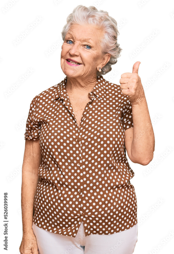 Senior grey-haired woman wearing casual clothes smiling happy and positive, thumb up doing excellent and approval sign - obrazy, fototapety, plakaty 