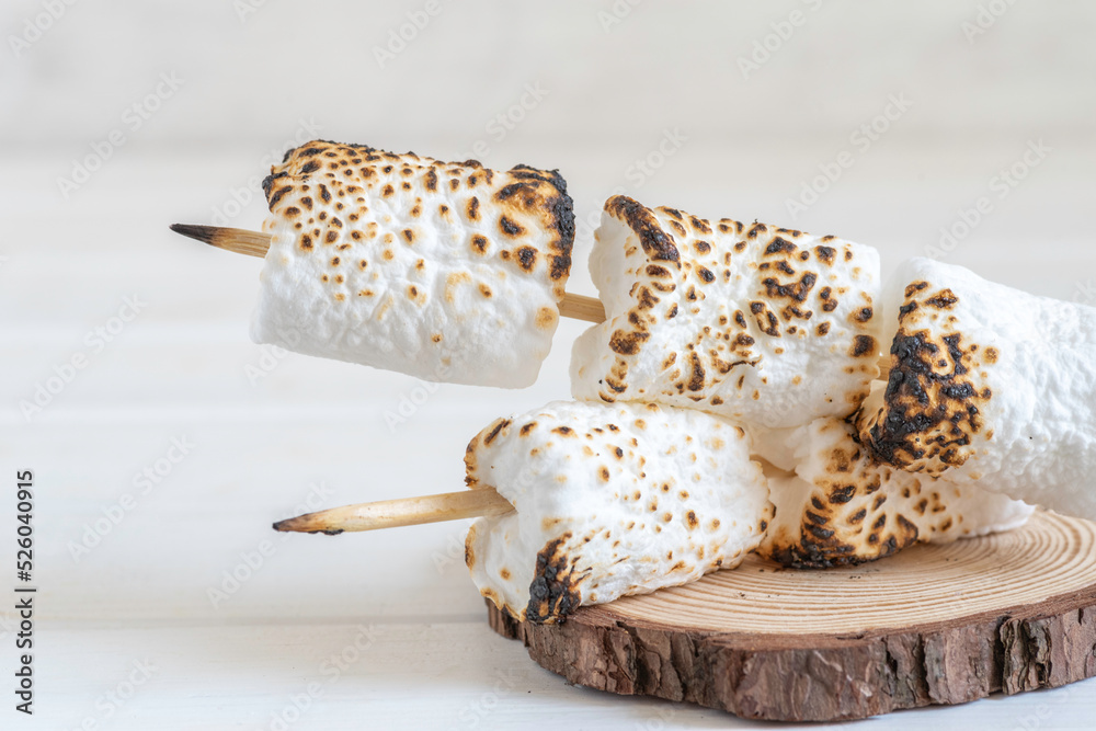 Roasted marshmallow on wooden background for Jewish holiday Lag BaOmer, for American Independence Day. 