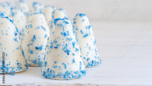 Israeli dessert Krembo in national blue and white colors for Independence Day of Israel. Cool candy covered with white and blue chocolate. photo